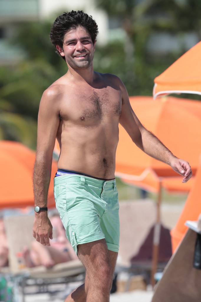 Adrian Grenier goes a shirtless dip while on the beach with his girlfriend in Miami
