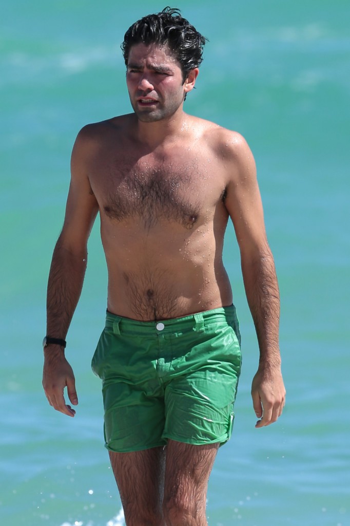 Adrian Grenier goes a shirtless dip while on the beach with his girlfriend in Miami