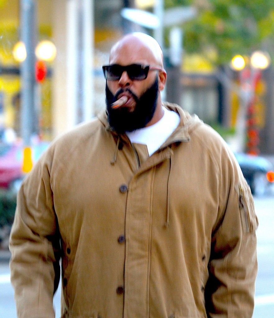 Hip-Hop Producer Suge Knight sighted smoking a cigar walking on Wilshire Boulevard