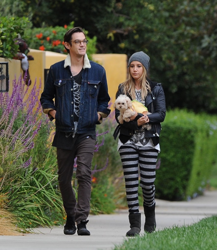 Ashley Tisdale and her husband Christopher French wear matching skeleton t-shirts on a walk with their pet dog