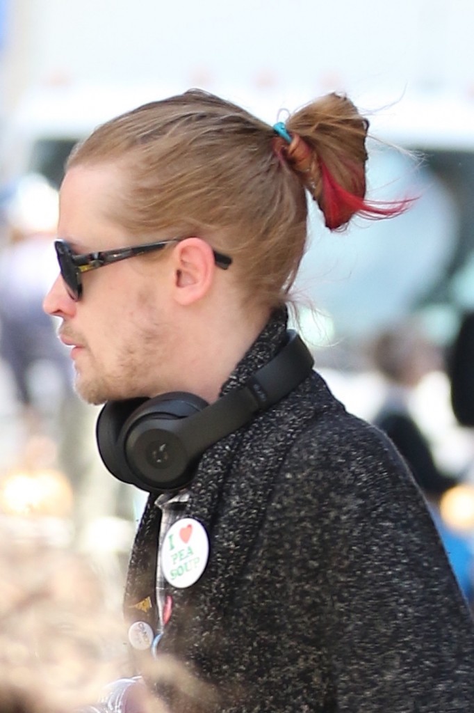 Macaulay Culkin sports a red streaked man bun as he takes a stroll in Soho