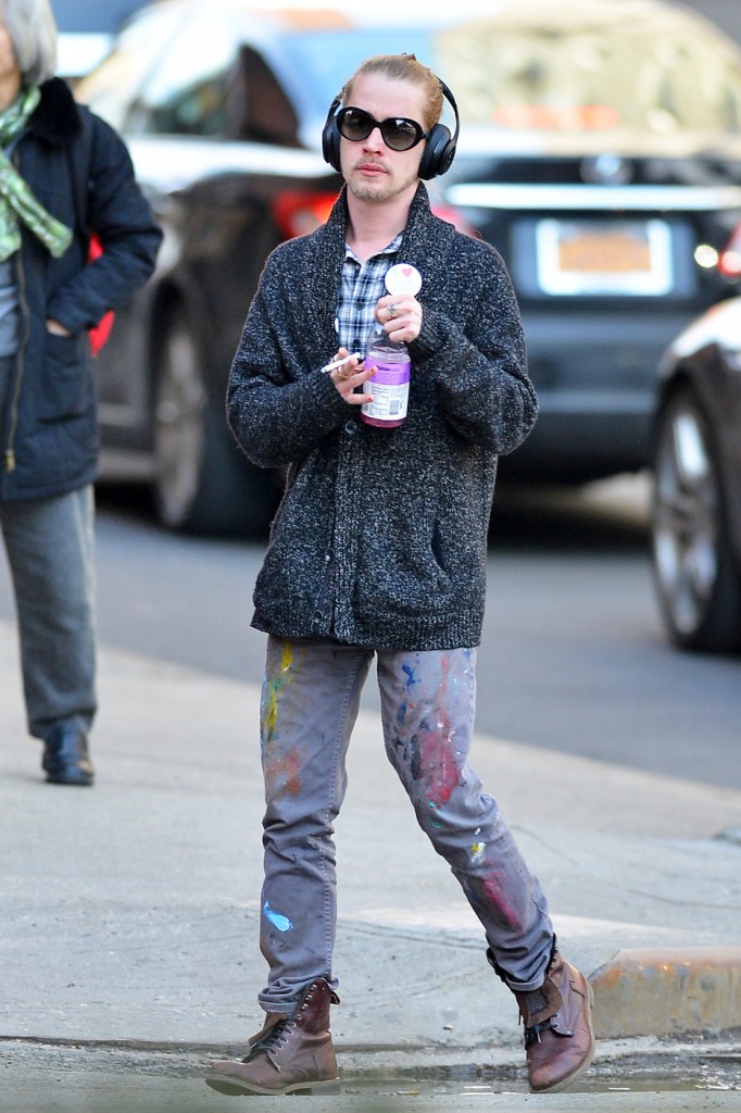 Macaulay Culkin smokes a cigarette as he takes an afternoon stroll around Soho