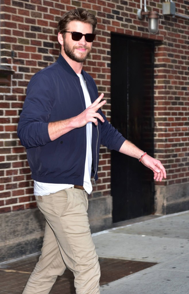 Liam Hemsworth exits the Late Show with Stephen Colbert and signs autographs for waiting fans