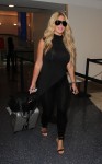 Kim Zolciak arrives for a flight with her daughters at LAX