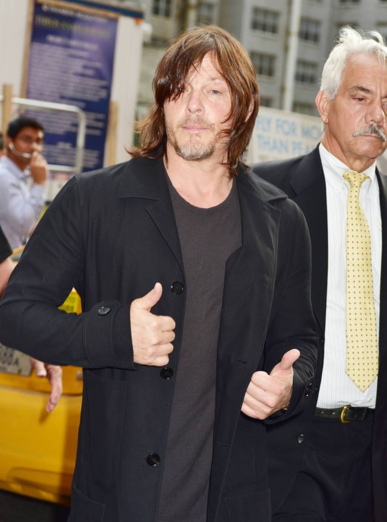 Norman Reedus gives a thumbs up  outside the studio entrance to the Late Show With Stephen Colbert
