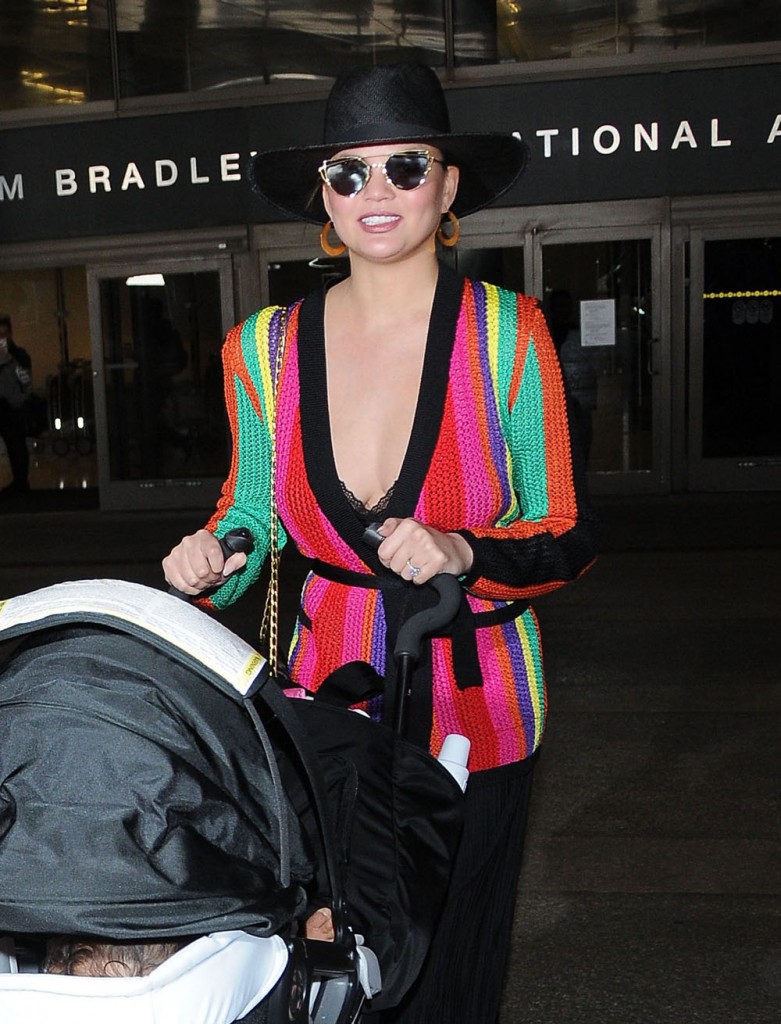 Chrissy Teigen & Daughter Arriving On A Flight At LAX