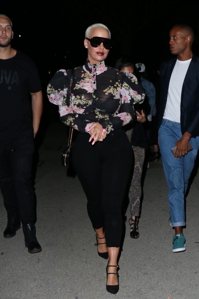 Amber Rose pairs her feminine yet see-through blouse with a metal grill as she arrives at ASAP Rocky's Guess Club in Los Angeles
