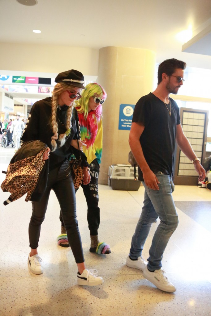 Rumored hot new couple, Scott Disick and Bella Thorne with Bella's sister Dani rush through LAX airport on their way to Cannes