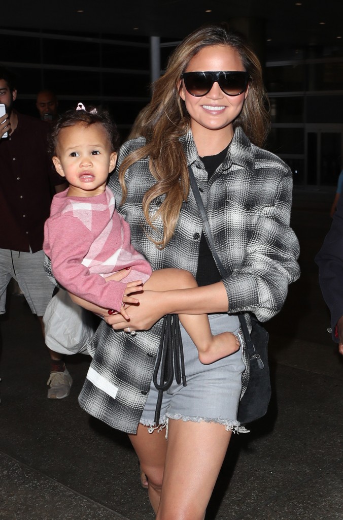 Chrissy Teigen arrives at LAX with her daughter