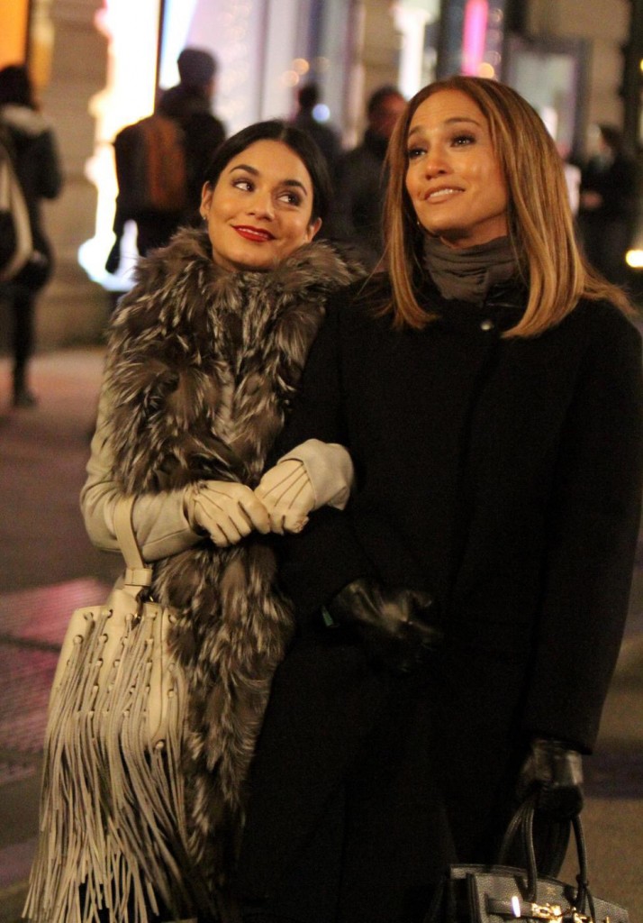 Jennifer Lopez and Vanessa Hudgens stroll arm-in-arm through Manhattan as they film an overnight scene at the Second Act movie set outside the Flatiron Building