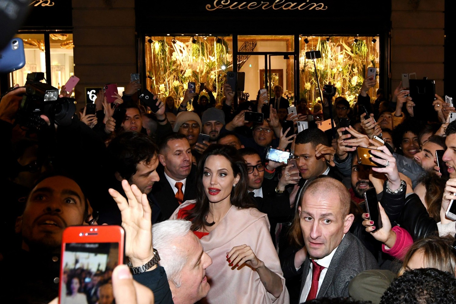 Angelina Jolie gets surrounded by fans as she leaves the Guerlain HQ