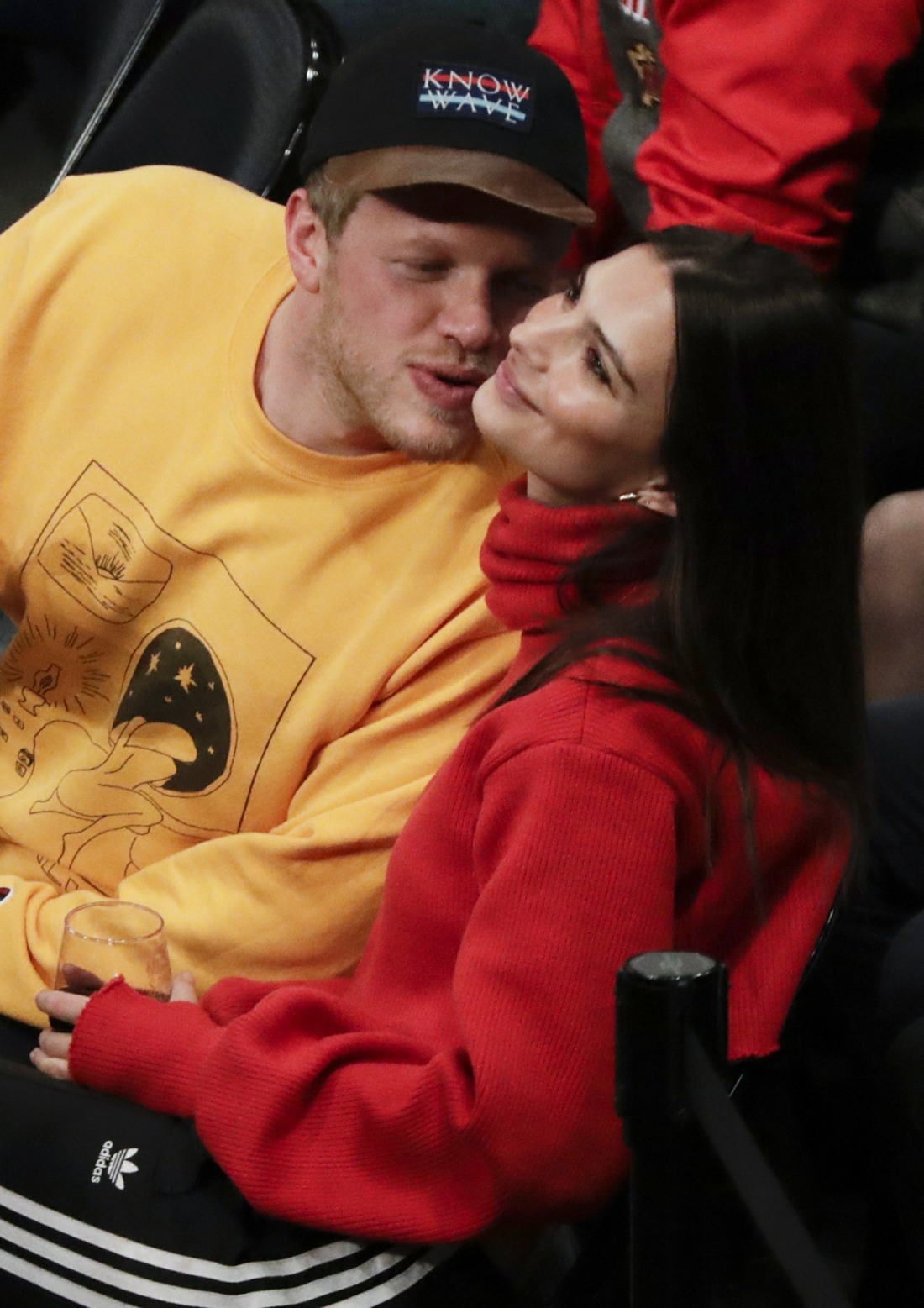 Emily Ratajkowski enjoys a drink and a game with a kiss happy mystery guy
