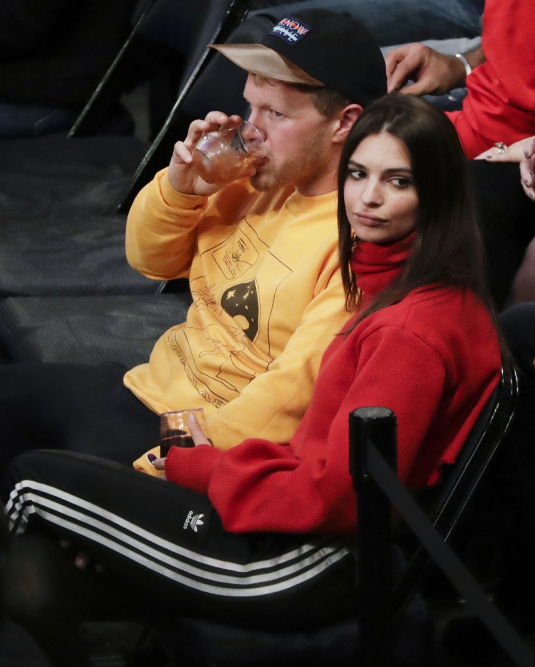 Emily Ratajkowski enjoys a drink and a game with a kiss happy mystery guy