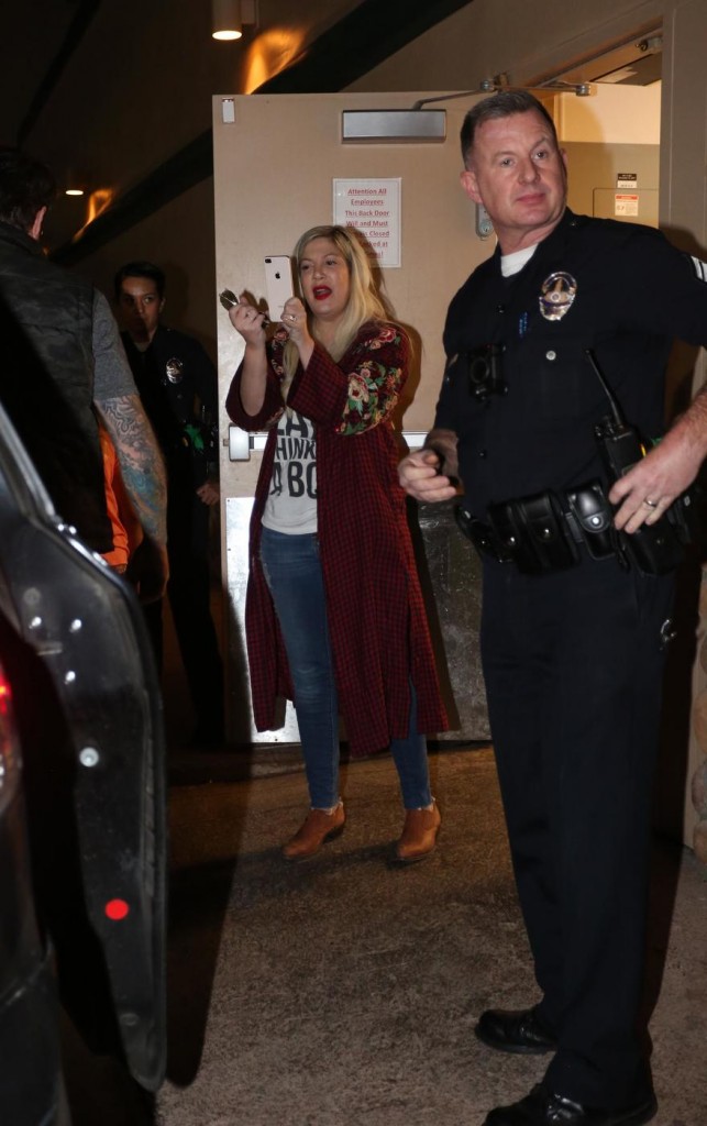 Tori Spelling and Dean McDermott are escorted out of Tarzana's Black Bear Diner by the LAPD after cops were called for a disturbance between the couple as they had dinner with their kids