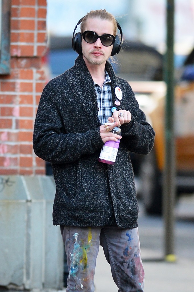 Macaulay Culkin smokes a cigarette as he takes an afternoon stroll around Soho