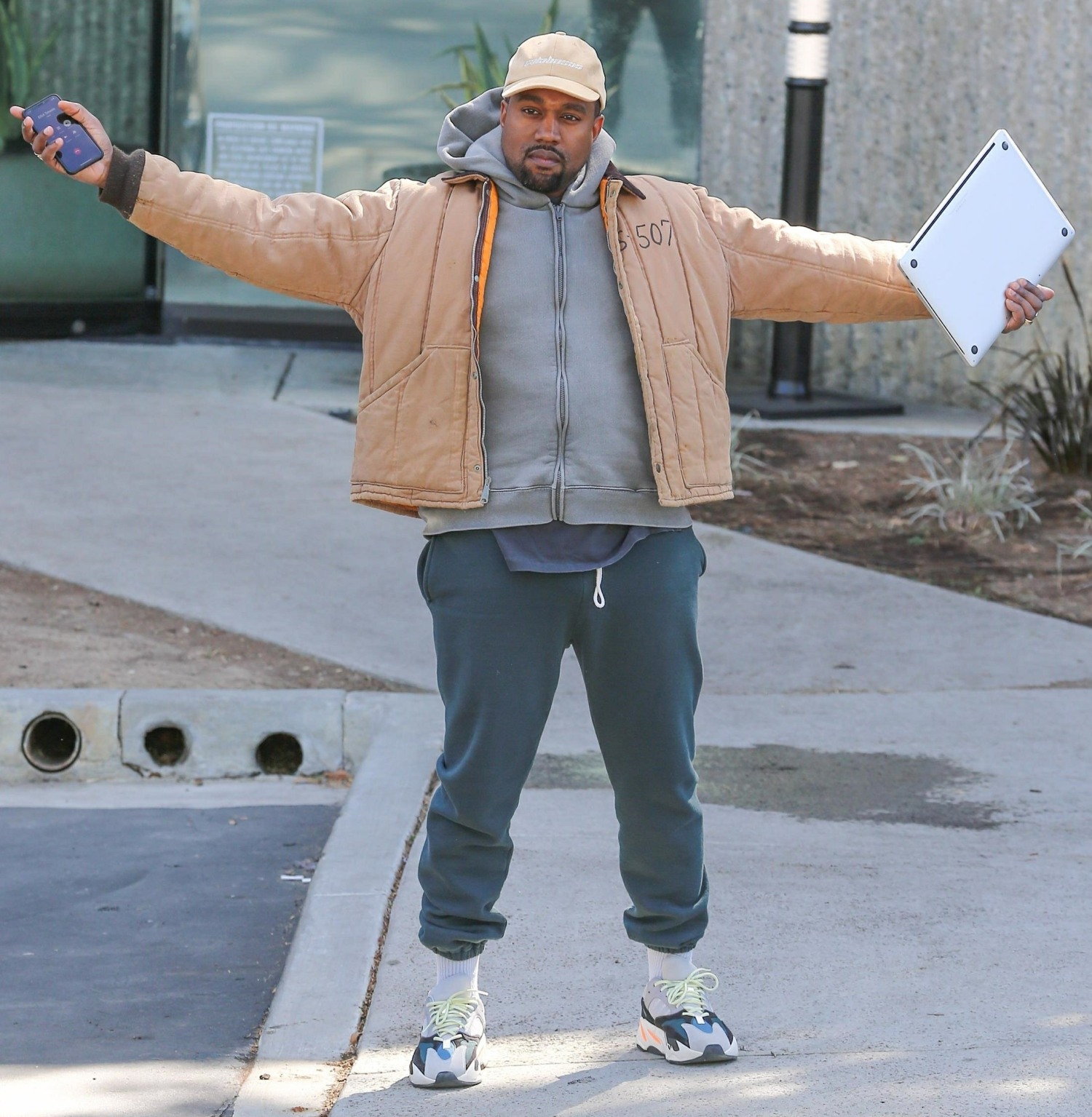 Kanye West greets our shutterbugs with open arms!