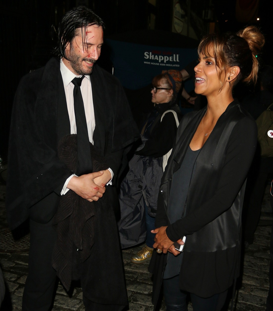 Halle Berry chats with Keanu Reeves on set of 'John Wick 3' during a late night of filming