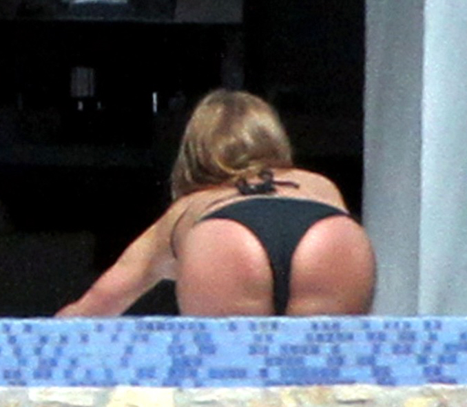 Jennifer Aniston dons black bikini, bends over for the paparazzi.
