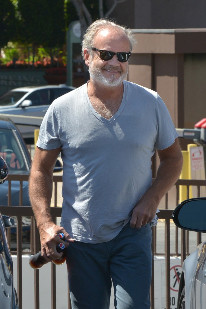 Kelsey Grammer Picking Up A Couple Of Cold Pepsi Bottles.