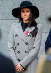 Meghan Markle looks on as Prince Harry lays a wreath at the Australian War Memorial at Hyde Park Corner to commemorate Anzac Day