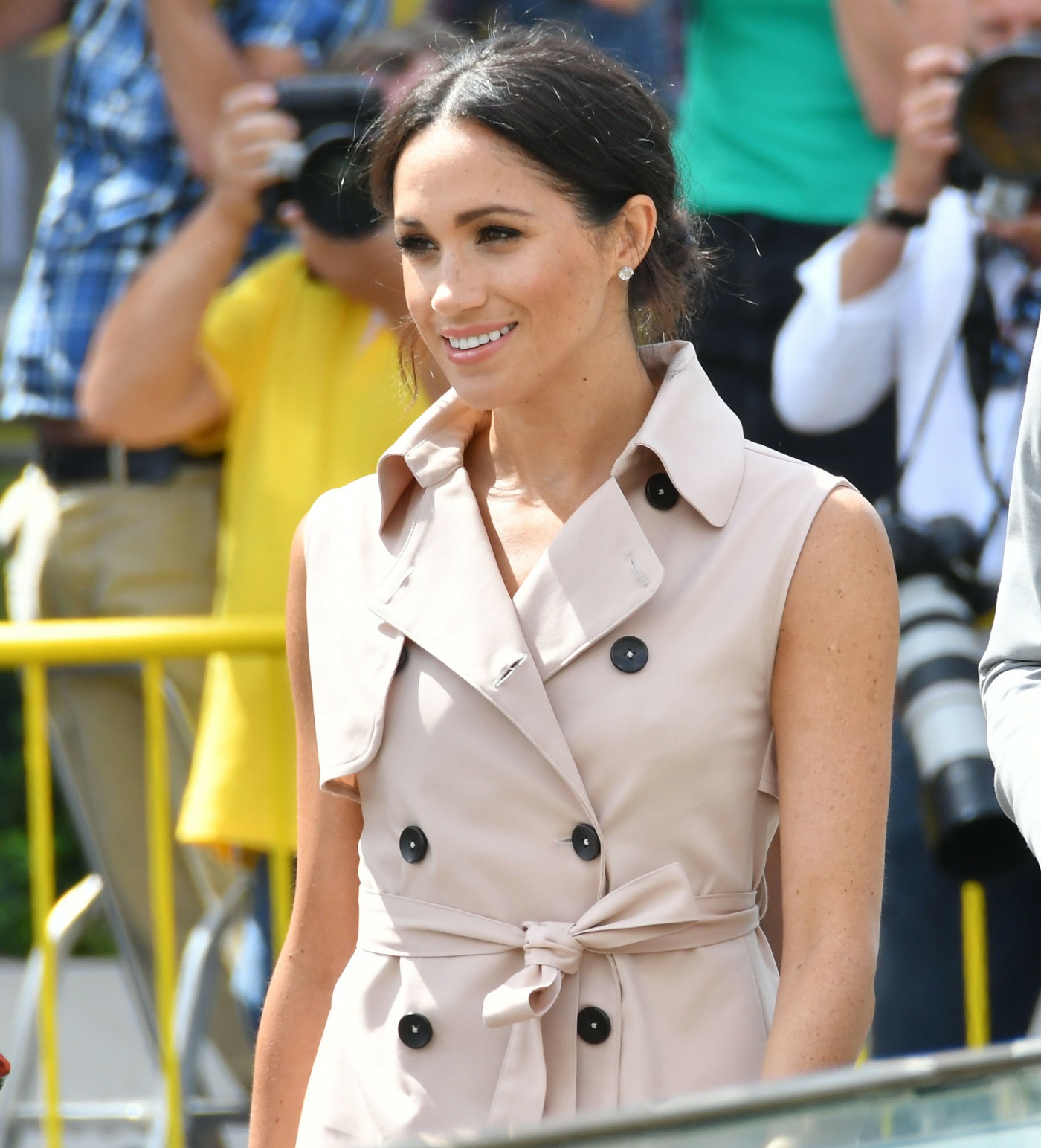 Meghan, Duchess of Sussex, wears a pale pink trench dress by House of Nonie as she visits the Nelson Mandela Centenary Exhibition at the Southbank Centre's Queen Elizabeth Hall in London with husband Prince Harry, Duke of Sussex