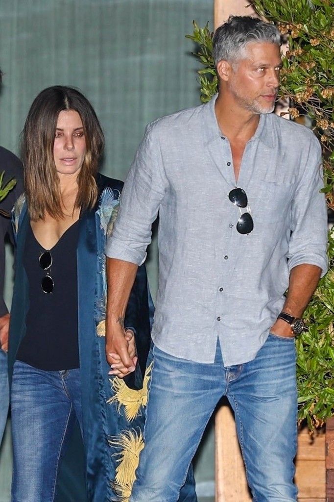 Sandra shows some PDA at Soho house with her beau after hanging out with friends