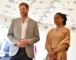 Britain's Prince Harry (L), Duke of Sussex and Doria Ragland listen to Meghan, Duchess of Sussex speaking at an event to mark the launch of a cookbook with recipes from a group of women affected by the Grenfell Tower fire at Kensington Palace in London on September 20, 2018.
