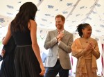 Meghan, Duchess of Sussex (L), her mother, Doria Ragland (R) and Britain's Prince Harry, Duke of Sussex take part in the launch of a cookbook with recipes from a group of women affected by the Grenfell Tower fire at Kensington Palace in London on September 20, 2018.