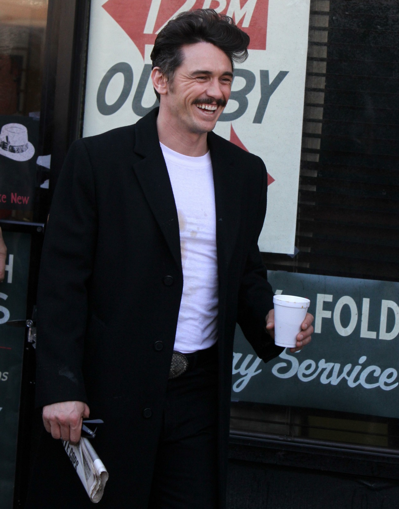 Tough guy James Franco swaps his folded newspaper for a biography of Joe Papp between takes on the set of HBO hit series 'The Deuce' in Bayridge, Brooklyn