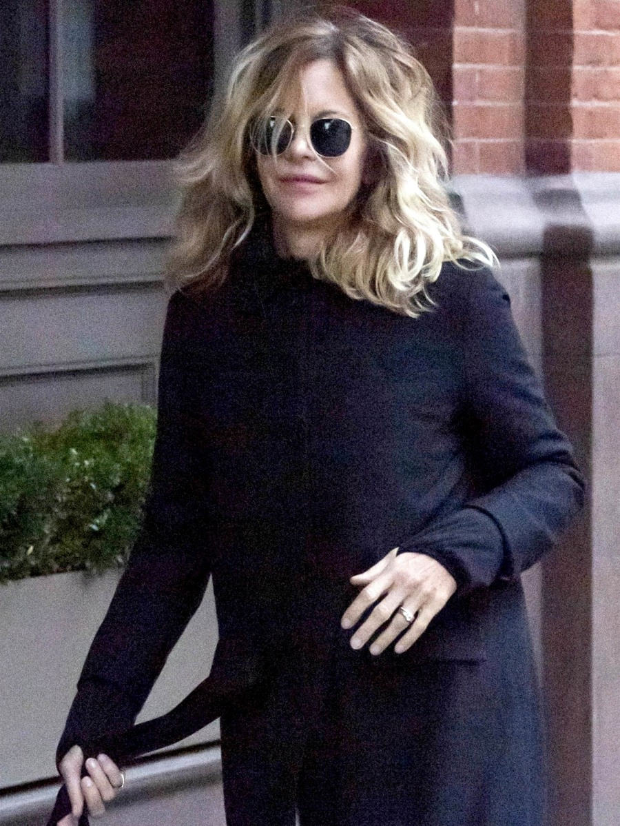Meg Ryan can't stop showing off her engagement ring as she waves to the photographers in NY