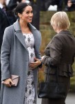Meghan Markle shows off growing baby bump while making a visit to the Royal Variety care home