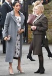 Meghan Markle shows off growing baby bump while making a visit to the Royal Variety care home