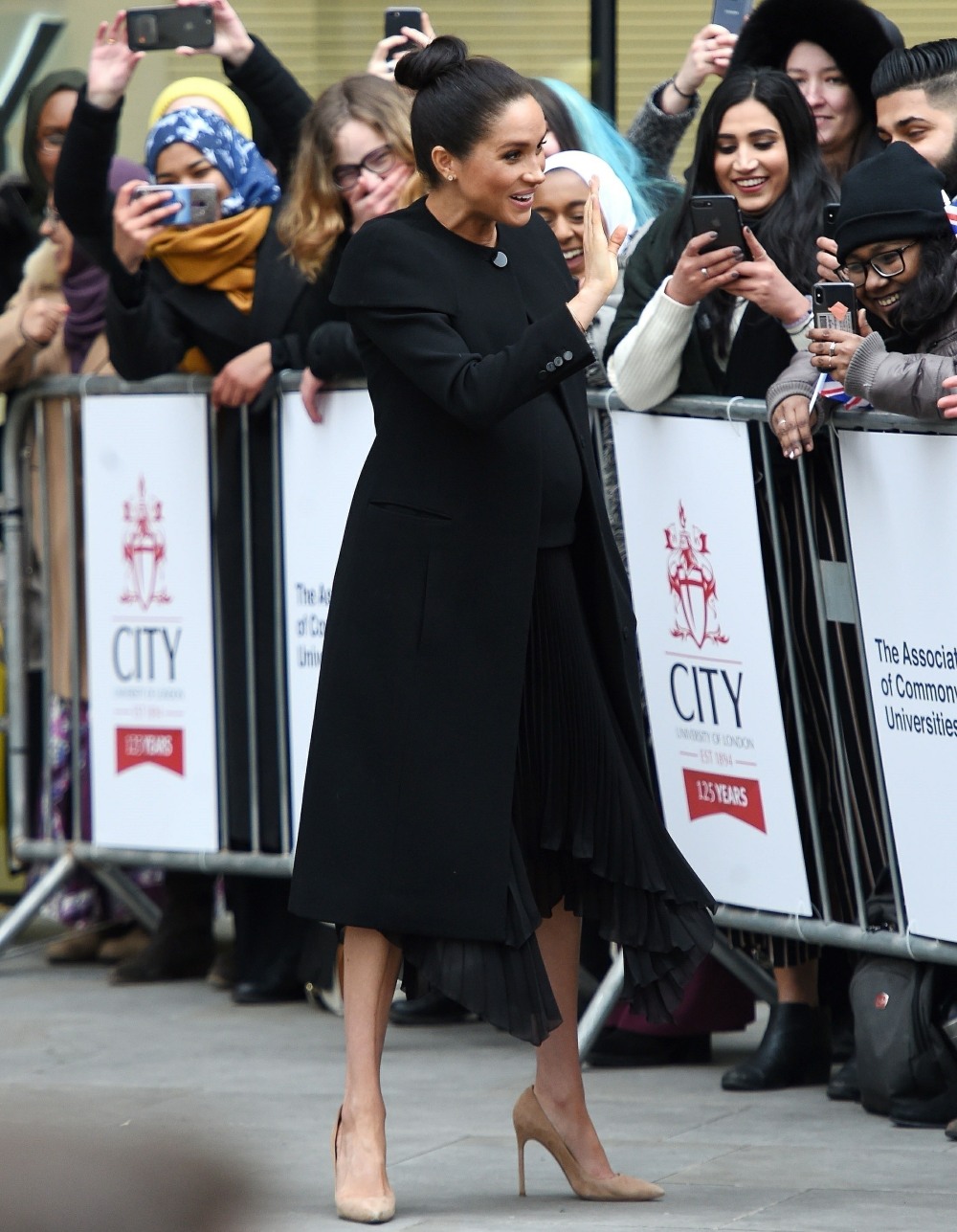 Pregnant Meghan Markle greets members of the public while leaving the Association of Commonwealth Universities in London