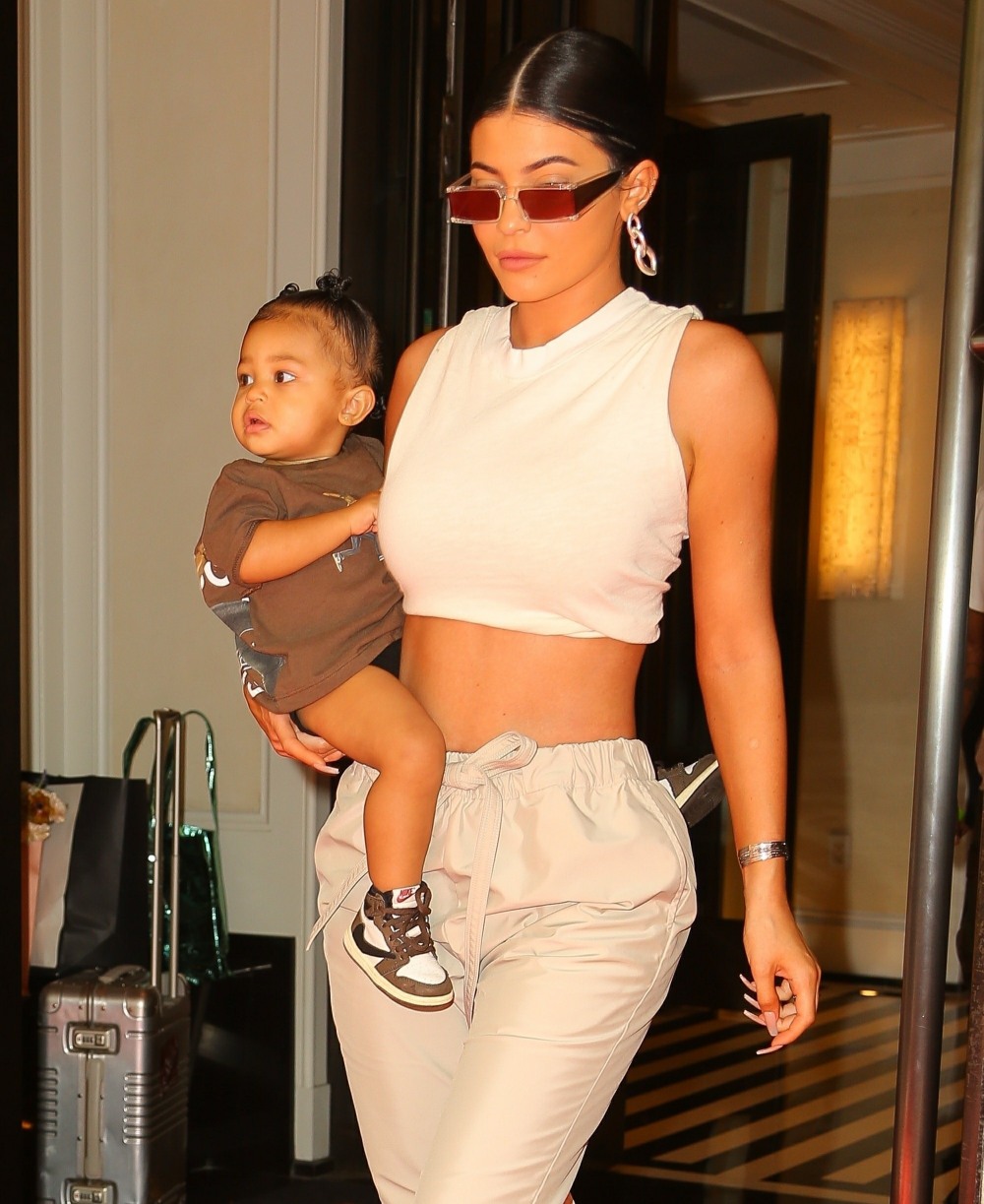 Baby Stormi dons custom Travis Scott Nike sneakers as she steps out of the Mark Hotel with mother Kylie Jenner