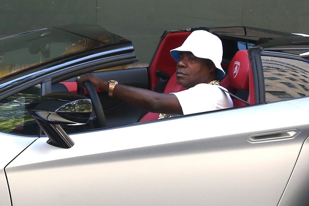 Tracy Morgan stops to greet fans while cruising around in his silver Lamborghini