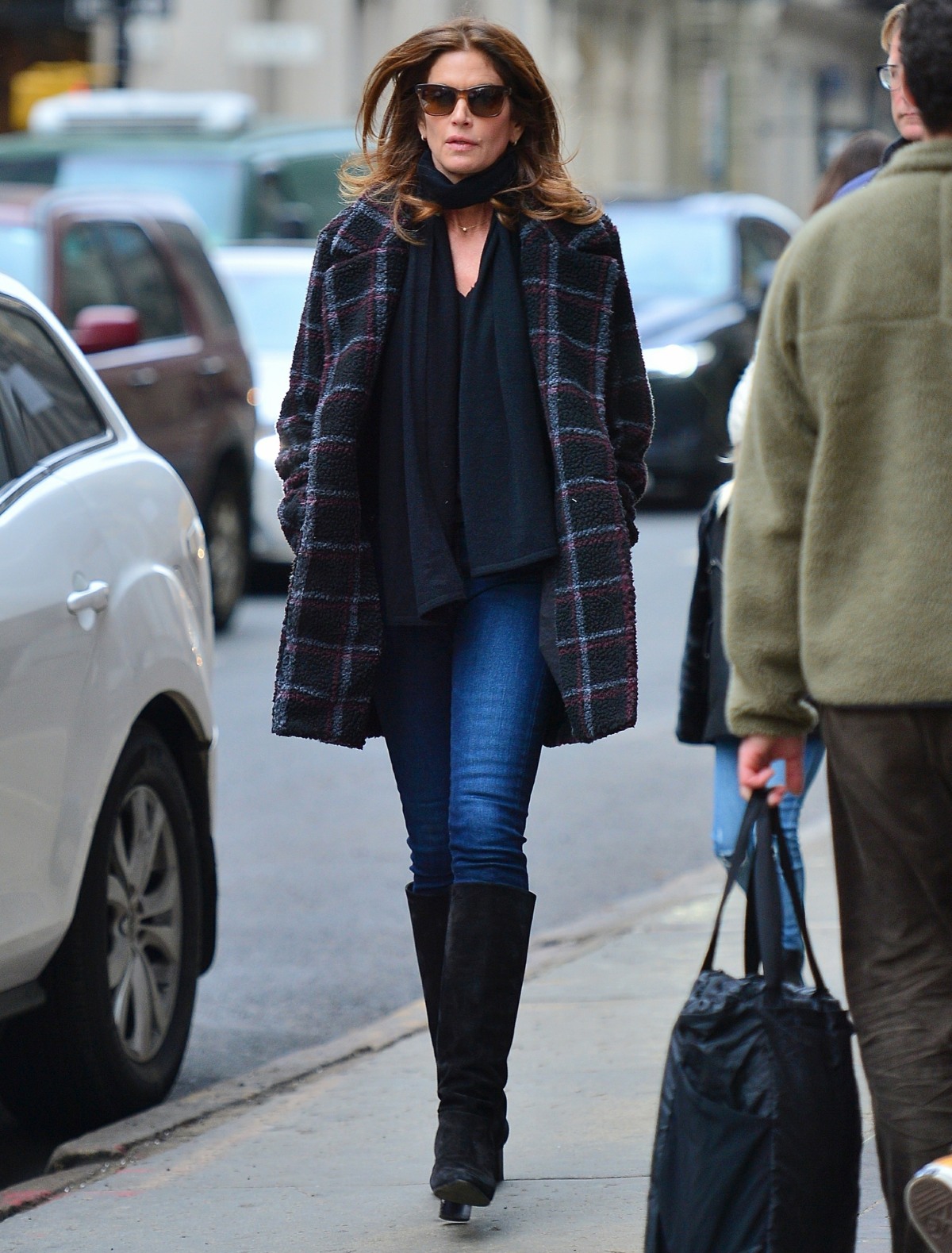 Cindy Crawford leaves her daughter Kaia's apartment in stylish plaid coat