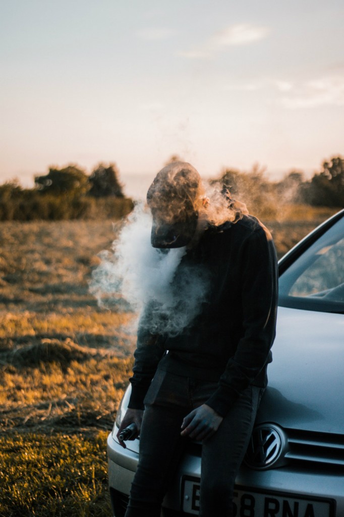 photo-of-a-man-sitting-on-vehicle-hood-2517681