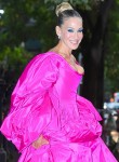 Sarah Jessica Parker heads out in an enormous fuchsia dress and mismatched shoes
