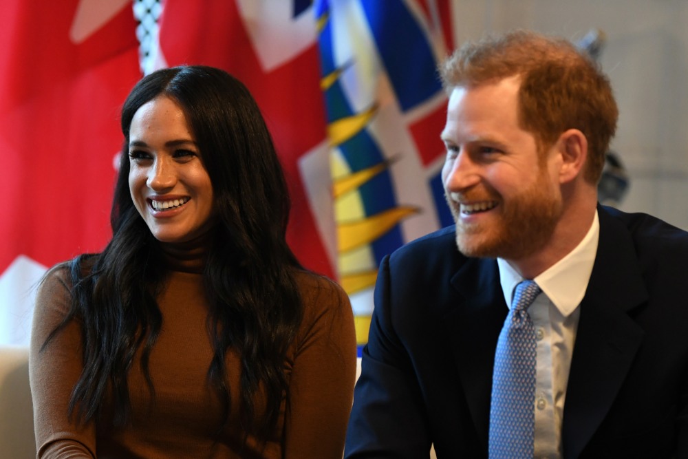 Britain's Prince Harry, Duke of Sussex and Meghan, Duchess of Sussex gesture during their visit to Canada House in thanks for the warm Canadian hospitality and support they received during their recent stay in Canada,  in London on January 7, 2020.