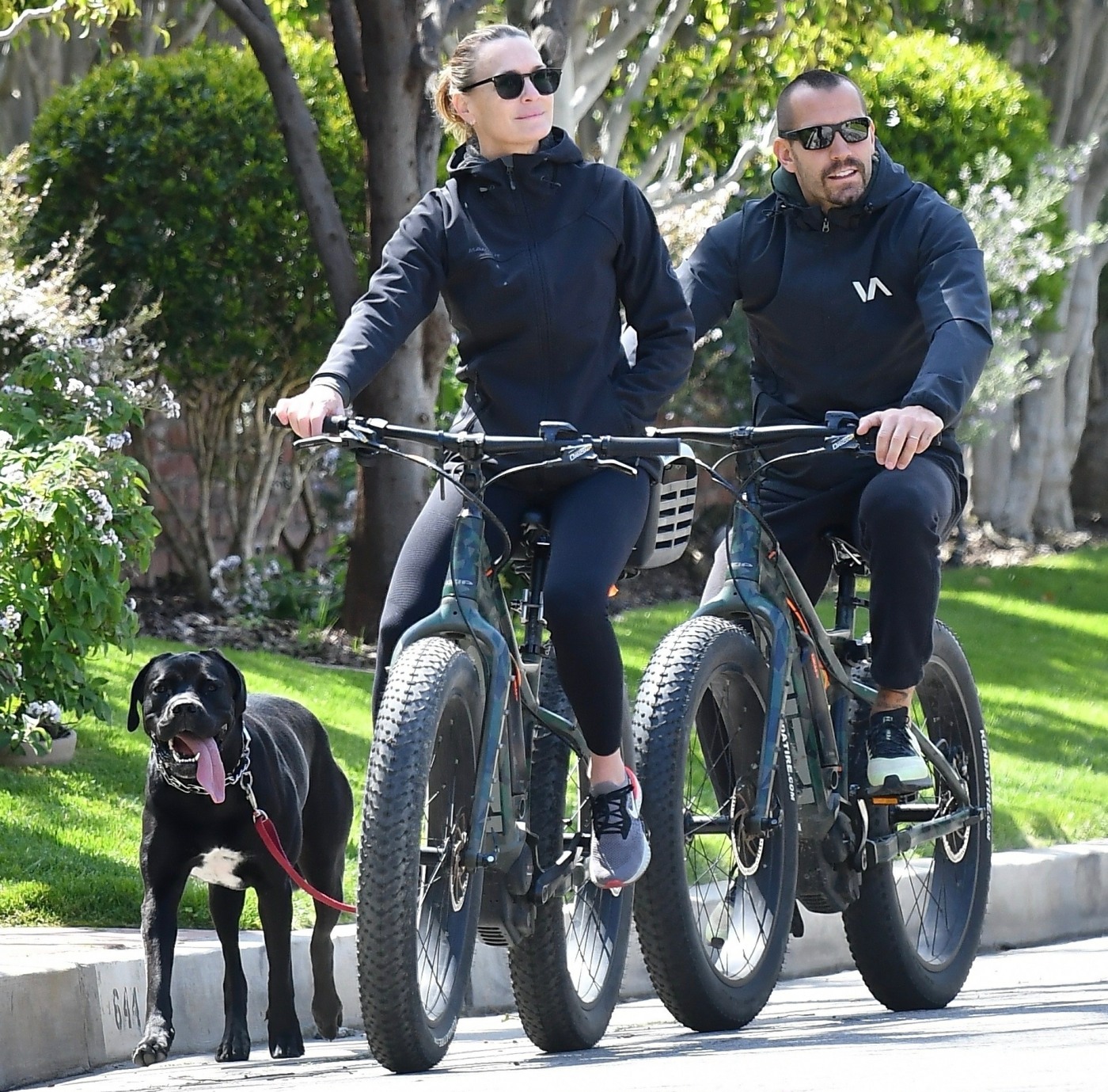 Robin Wright Clement Giraudet ride their bikes with their dog