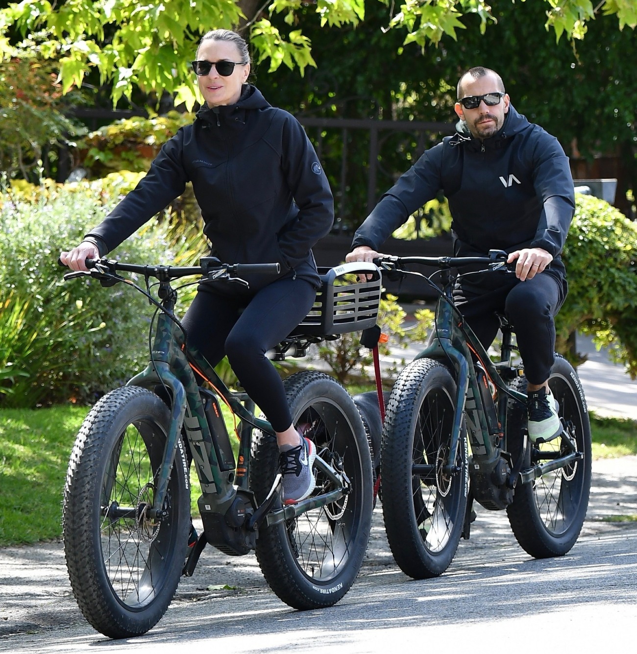 Robin Wright Clement Giraudet ride their bikes with their dog