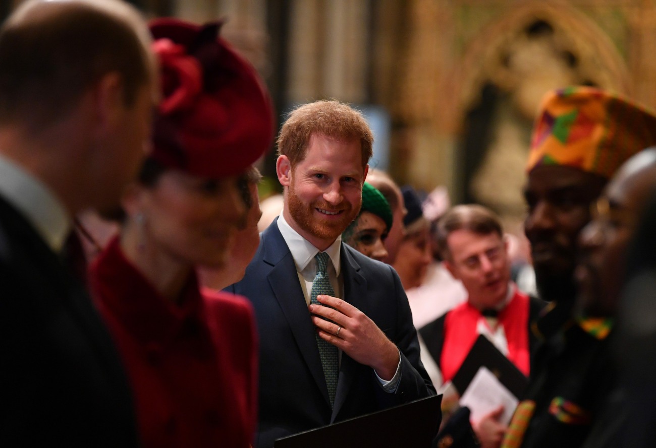 Britain's Prince Harry, Duke of Sussex (C) is introduced to performers as he leaves after attending  the annual Commonwealth Service at Westminster Abbey in London on March 09, 2020. - Britain's Queen Elizabeth II has been the Head of the Commonwealth thro