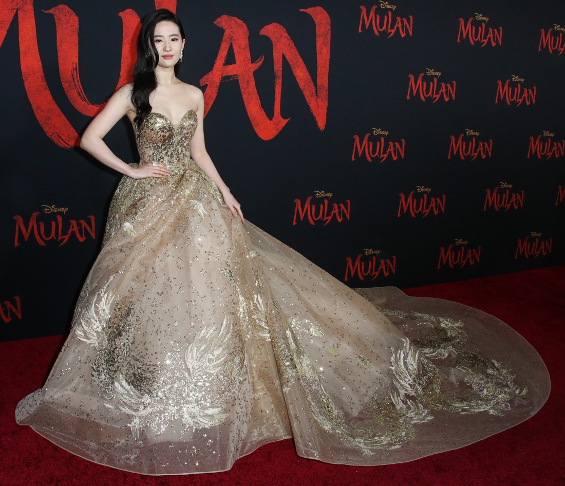 Actress Yifei Liu wearing a shimmering gold, str...