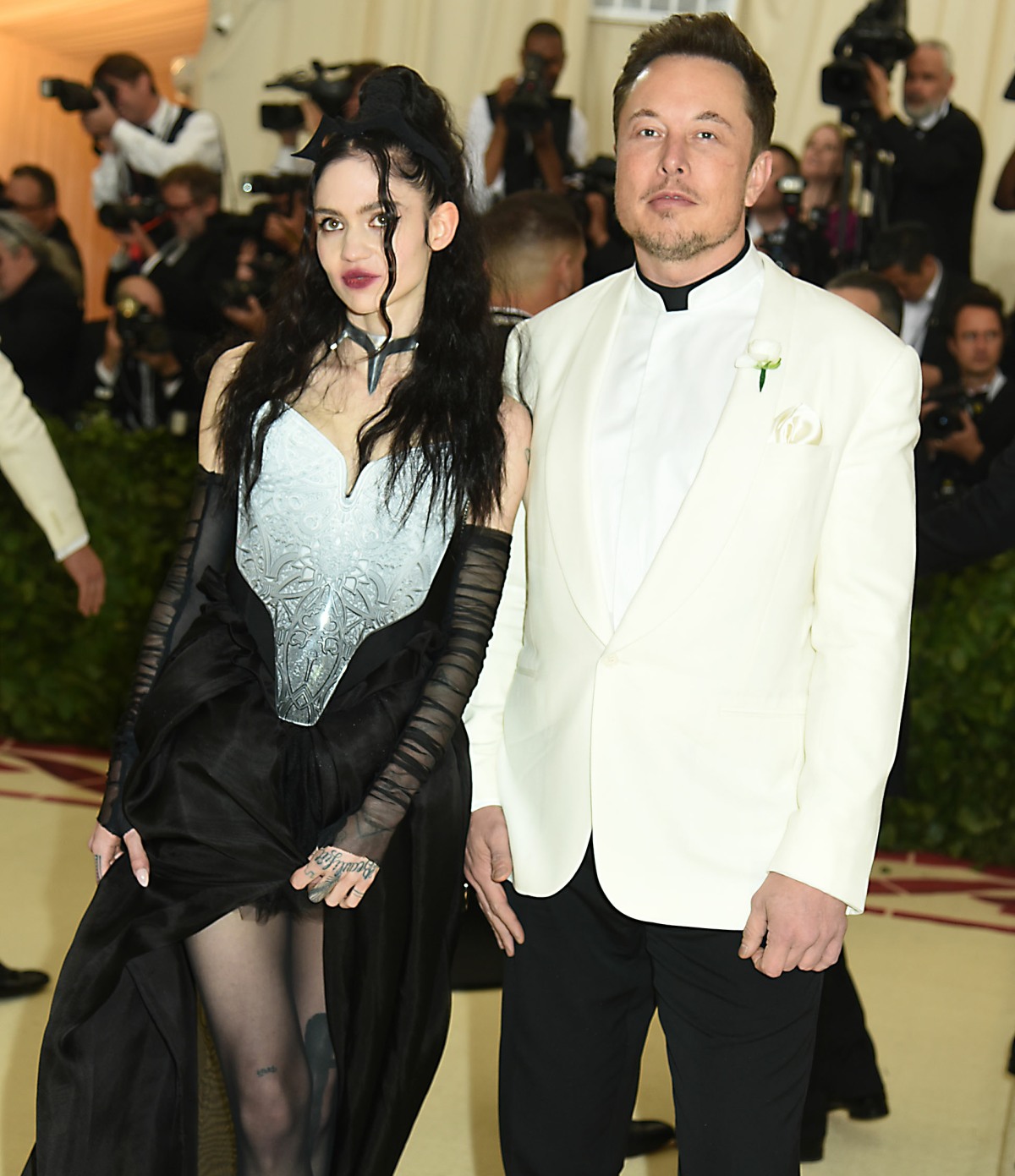 Grimes and Elon Musk at the Costume Institute Benefit at the Metropolitin Museum of Art at the opening of 'Heavenly Bodies: Fashion and the Catholic Imagination' in New York City