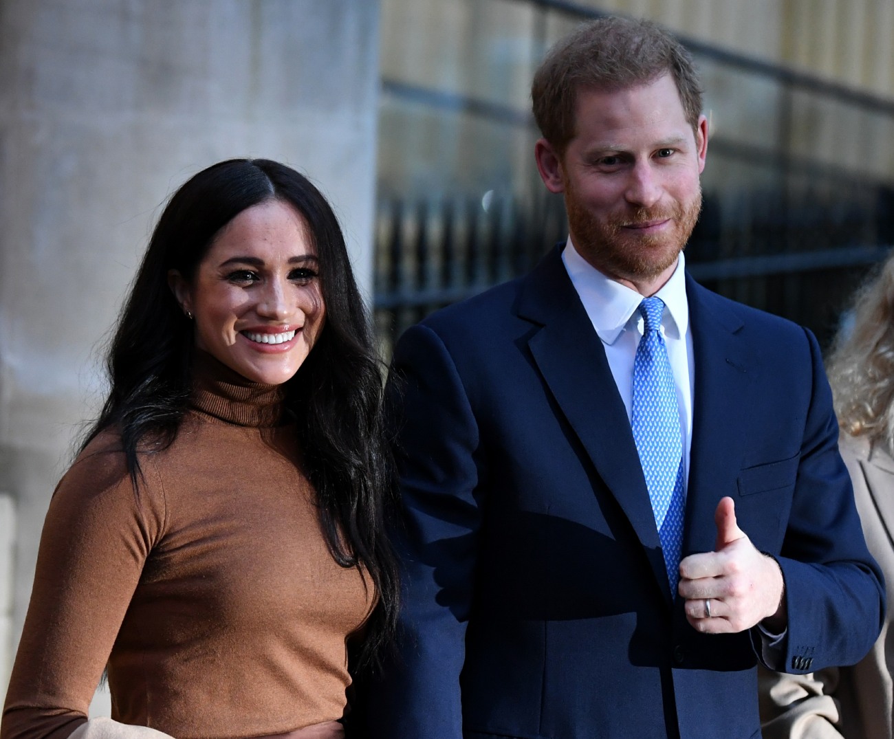 Britain's Prince Harry, Duke of Sussex (C) and Meghan, Duchess of Sussex (L) stand with Canada's High Commissioner for Canada in the United Kingdom, Janice Charette, as they leave after their visit to Canada House in thanks for the warm Canadian hospitalit