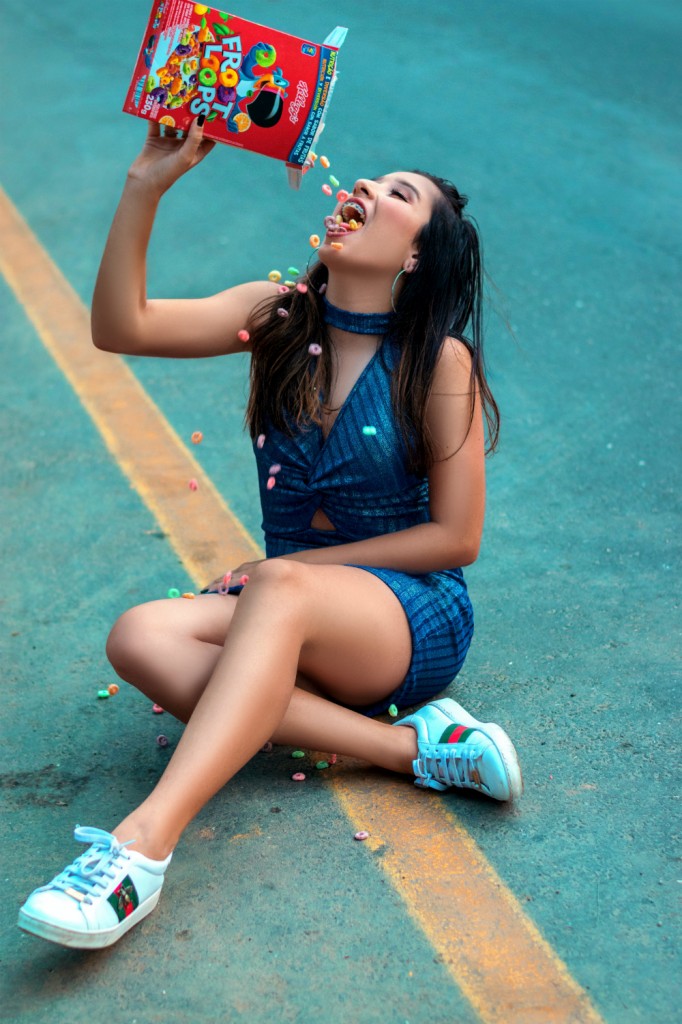 woman-sitting-on-the-road-eating-froot-loops-1805405