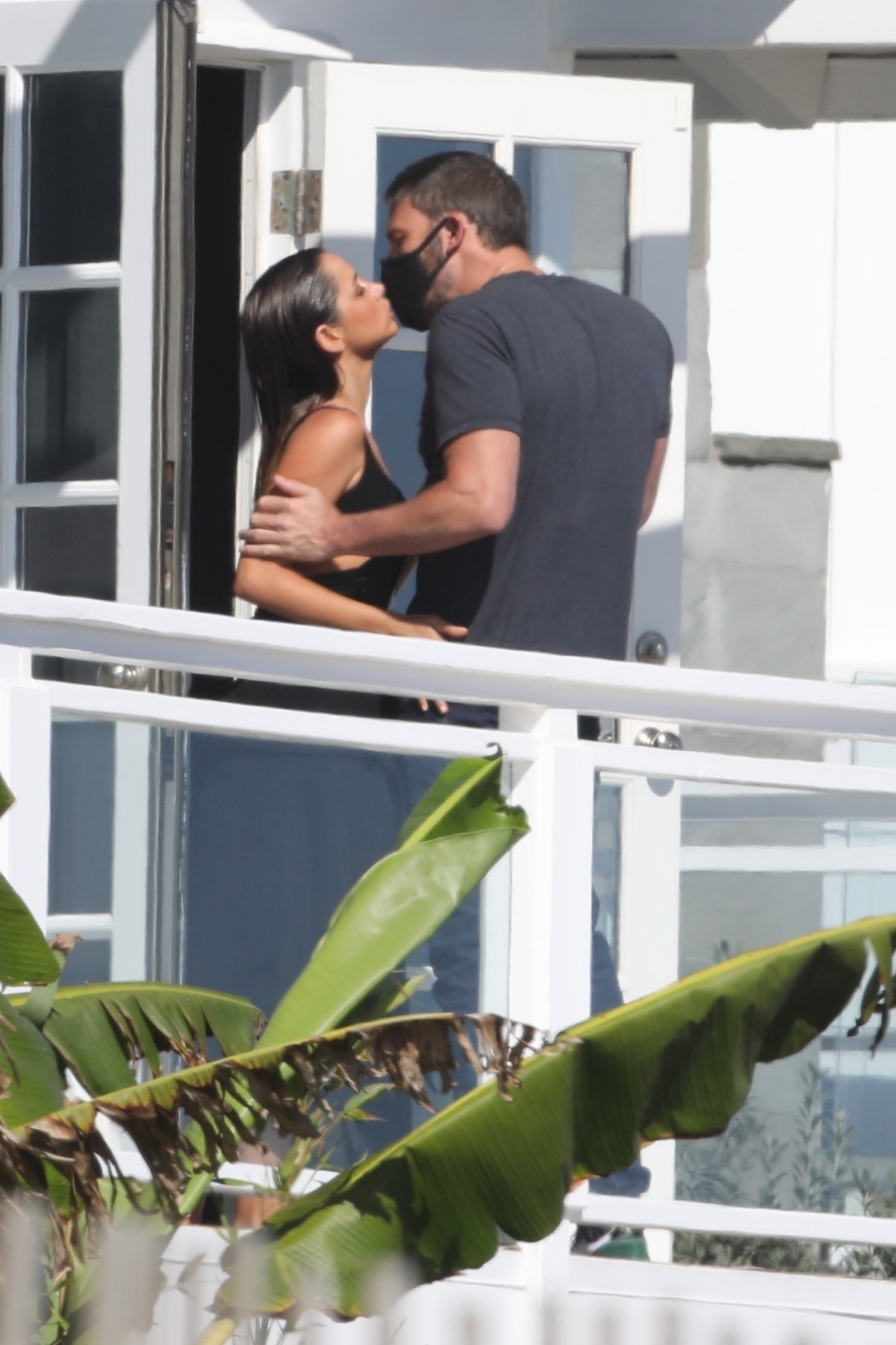 Ben Affleck's girlfriend Ana de Armas pulls down his mask for a kiss at a beach photoshoot