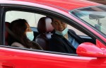 Katie Holmes and boyfriend Emilio Vitolo walk hand-in-hand as they go for a joyride in his red Pontiac