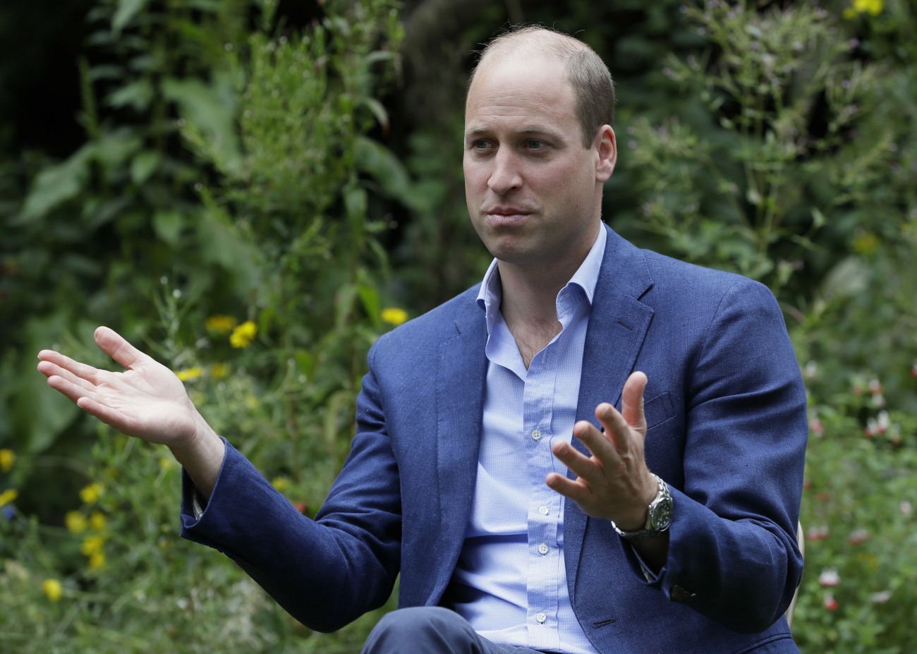 Britain's Prince William speaks with service users during a visit to the Garden House part of the Light Project in Peterborough, England, Thursday, July 16, 2020. The Garden House offers information, advice and support to the rough sleepers in Peterborough.