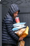 Ben Affleck grabs packages that were delivered to his house while sipping his coffee